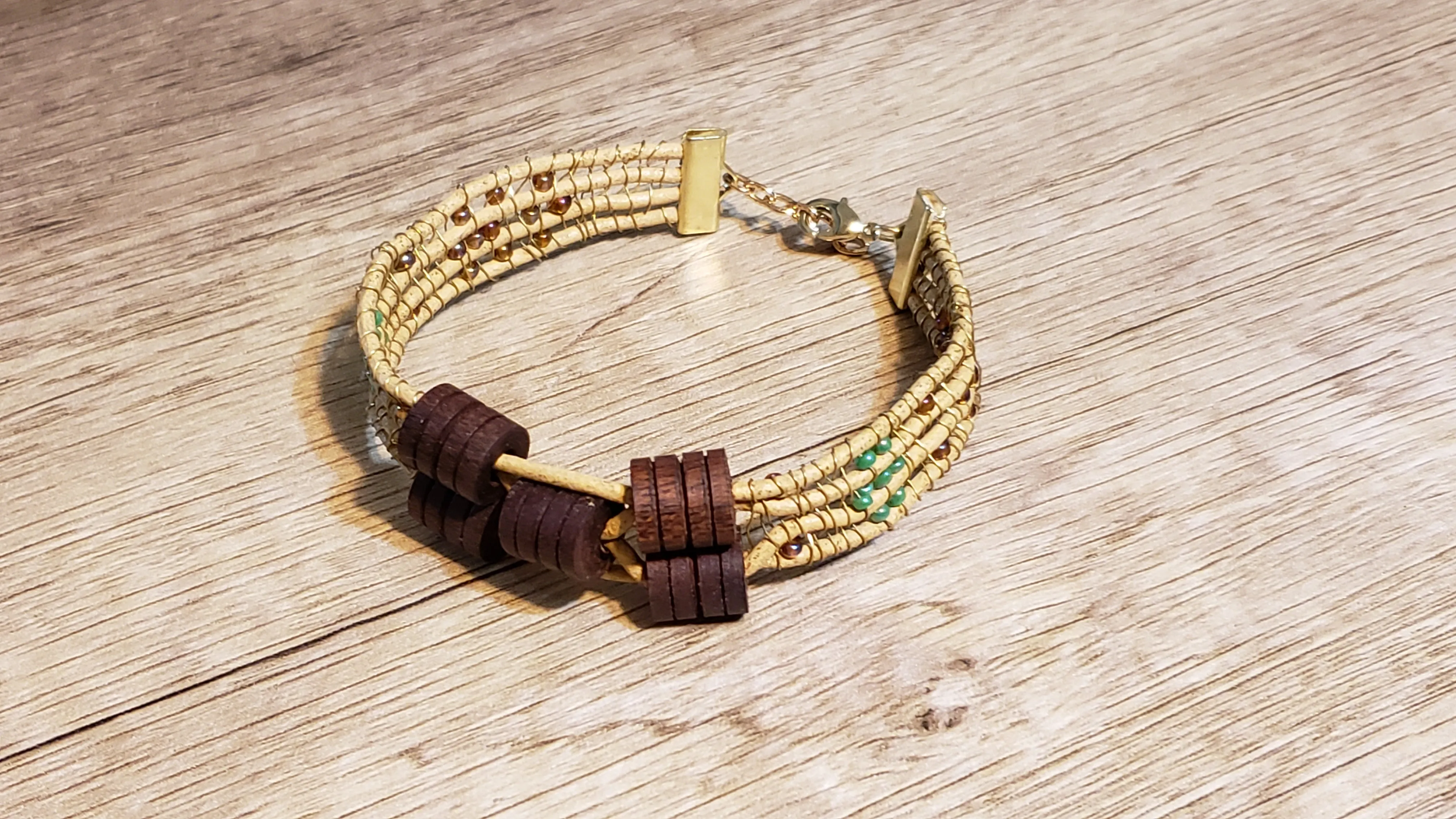 Genuine Leather Bracelet with Wood Beads, Wire & Glass. Adjustable Non Tarnish Gold Tone Chain, with Lobster Claw Clasp.