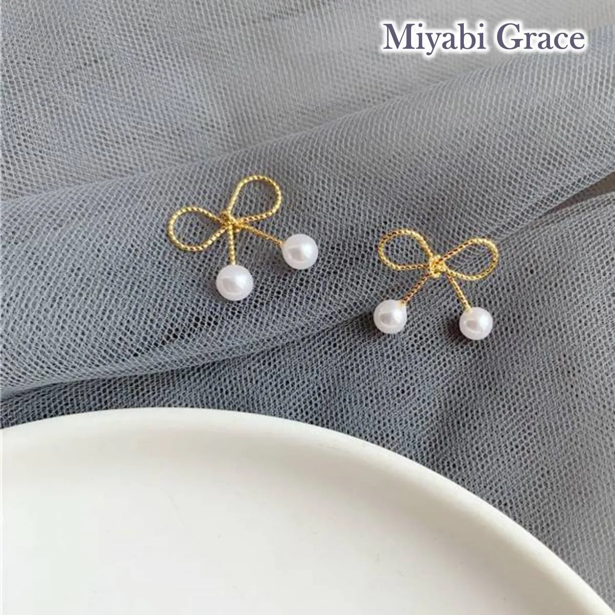 Gold Ribbon White Pearl Tie Invisible Clip On Stud Earrings