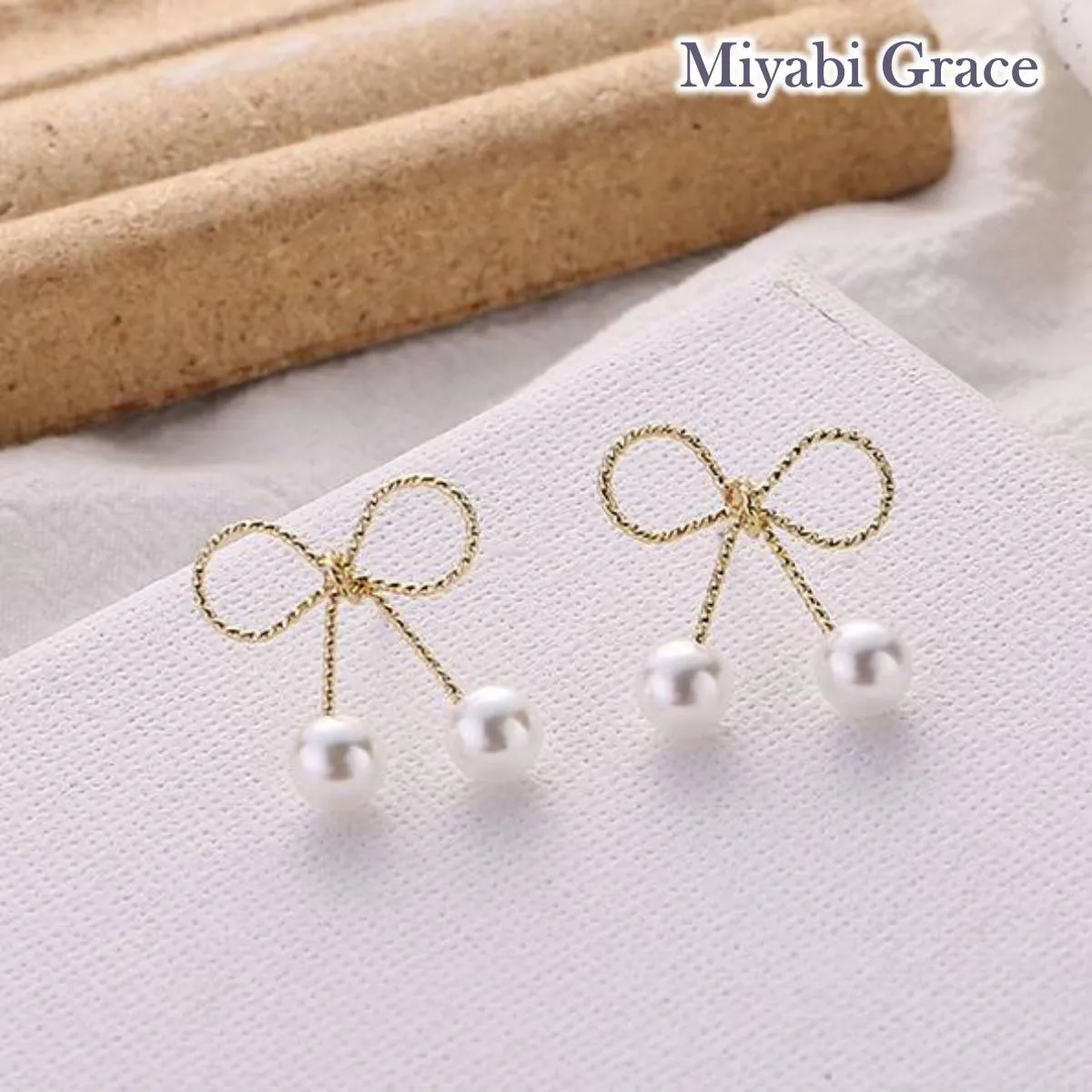 Gold Ribbon White Pearl Tie Invisible Clip On Stud Earrings