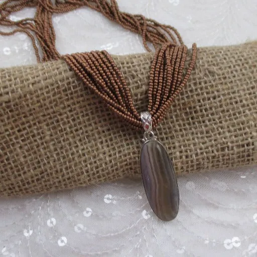 Multi-strand Golden Brown Necklace with a Fluorite Gemstone Pendant